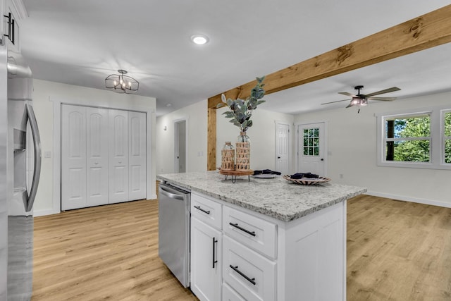 kitchen with light stone countertops, light wood-type flooring, white cabinetry, and stainless steel appliances