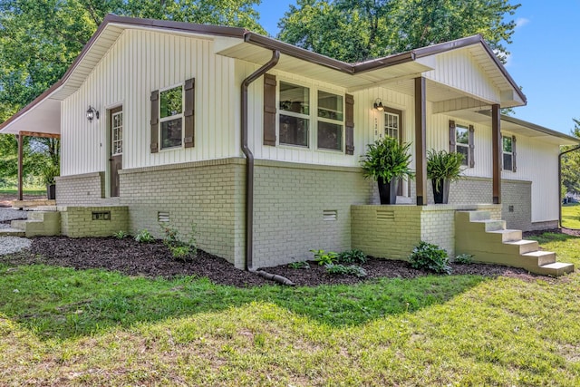 view of home's exterior with a yard and a porch