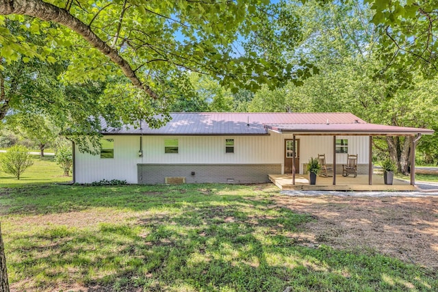 back of property featuring a lawn