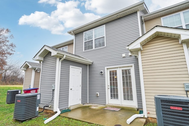 rear view of property featuring central air condition unit