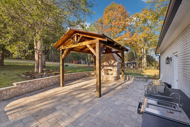 view of patio / terrace with a gazebo and an outdoor brick fireplace