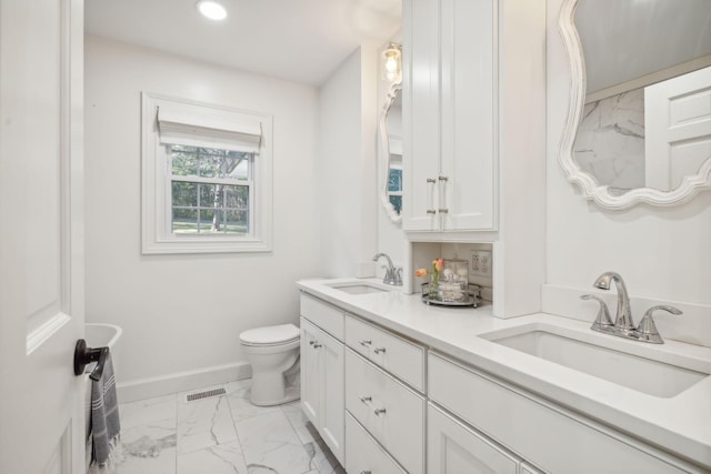 bathroom featuring vanity and toilet