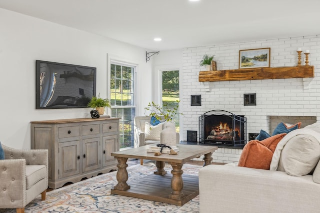 living room with a brick fireplace