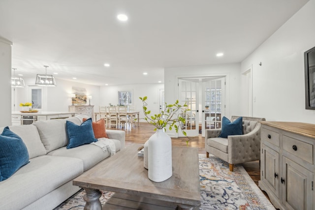 living room with french doors and light hardwood / wood-style flooring