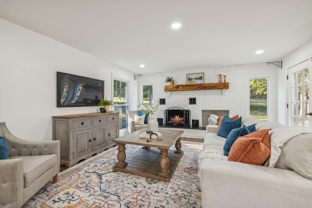 living room with a brick fireplace