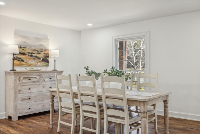 dining space with dark hardwood / wood-style flooring