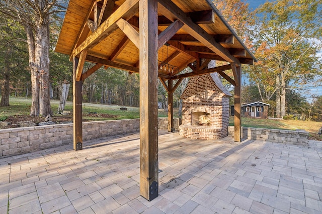 view of patio / terrace with an outbuilding and an outdoor brick fireplace