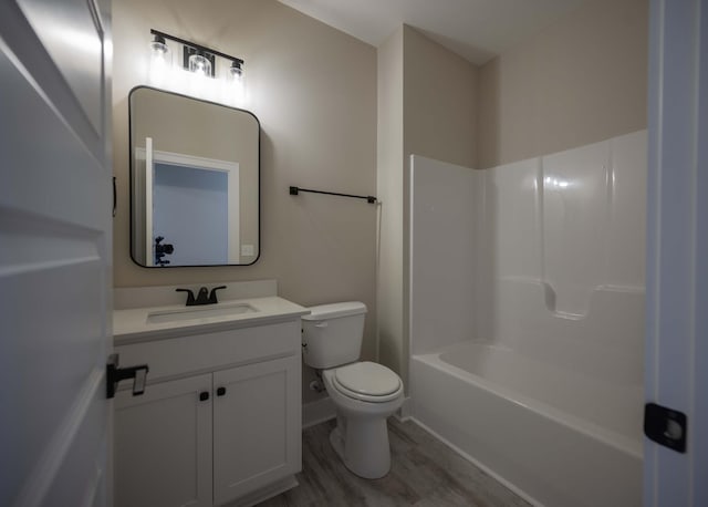 full bathroom with wood-type flooring, vanity, toilet, and  shower combination