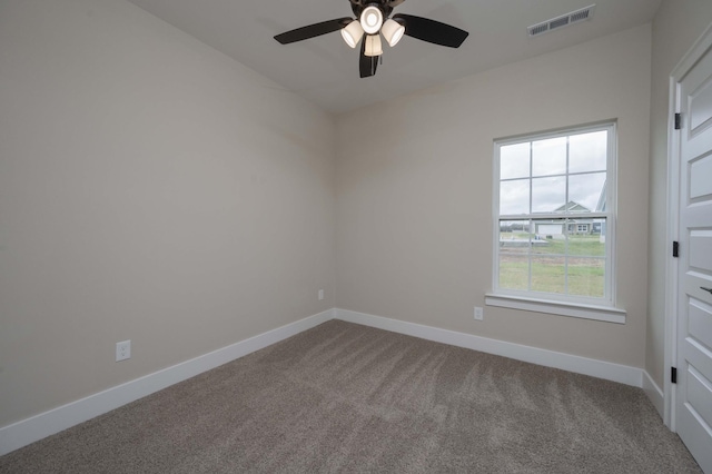 carpeted spare room with ceiling fan