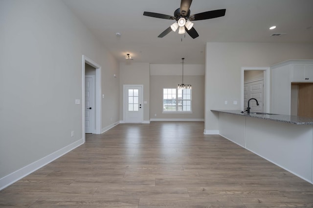 10118 Bighorn Ln, Bell Buckle, TN 37020 - unfurnished living room with a ceiling fan, a chandelier, and light wood finished floors