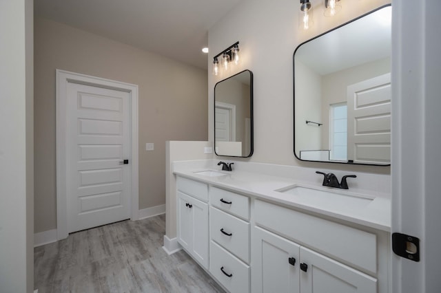 bathroom with hardwood / wood-style floors and vanity