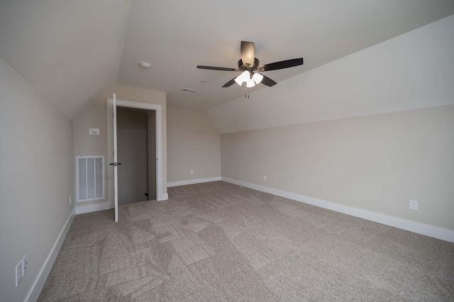 additional living space featuring light carpet, vaulted ceiling, and ceiling fan