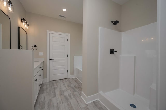 10118 Bighorn Ln, Bell Buckle, TN 37020 - bathroom featuring vanity, wood finished floors, a bath, a shower, and recessed lighting