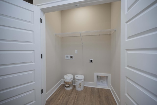 clothes washing area featuring hardwood / wood-style flooring, hookup for a washing machine, and hookup for an electric dryer