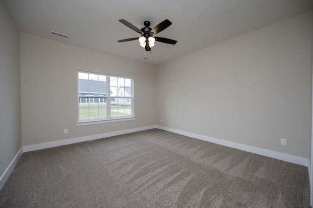 carpeted spare room with ceiling fan