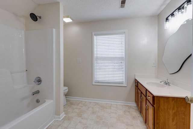 full bathroom with bathing tub / shower combination, vanity, a textured ceiling, and toilet