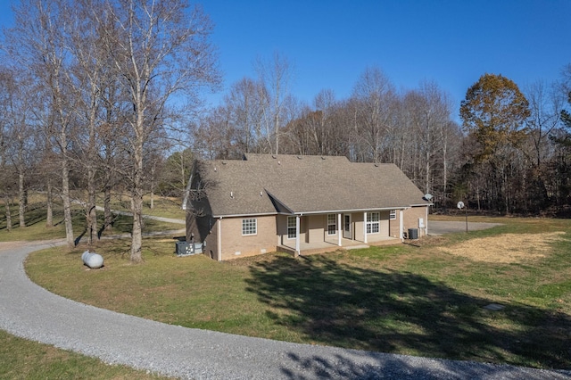 view of front of property with cooling unit, a porch, and a front yard