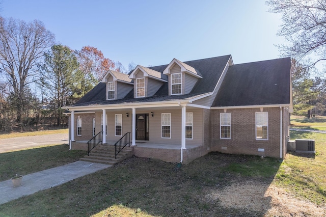 cape cod-style house with covered porch, central AC unit, and a front yard