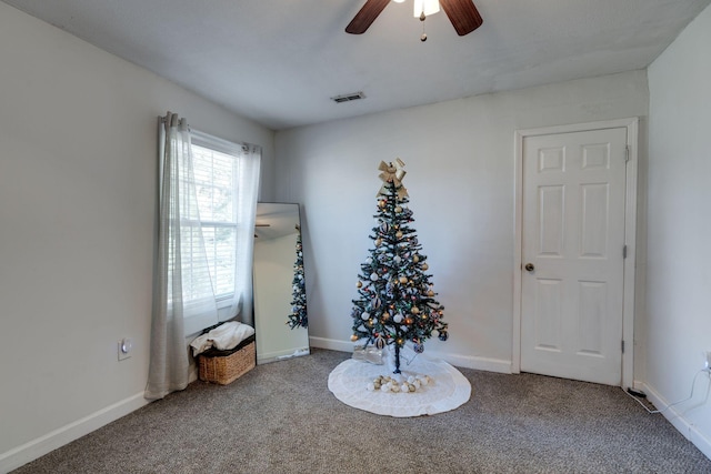 interior space featuring carpet flooring and ceiling fan