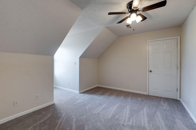 bonus room with carpet flooring, a textured ceiling, and ceiling fan