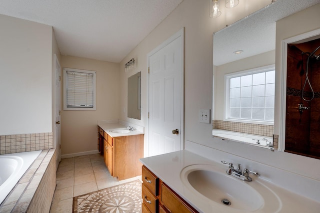 bathroom featuring tile patterned flooring, vanity, separate shower and tub, and a textured ceiling