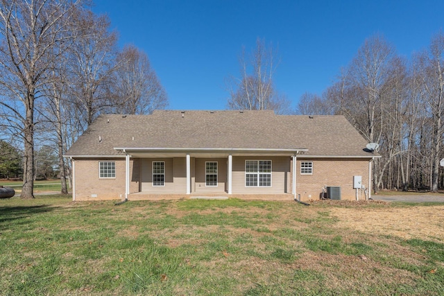 back of property featuring cooling unit and a lawn