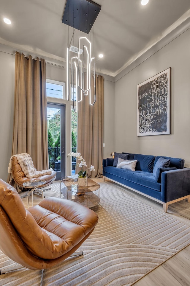 living room with wood-type flooring and ornamental molding