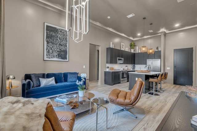 living room featuring light hardwood / wood-style flooring and ornamental molding