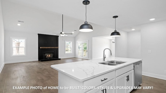 kitchen featuring pendant lighting, sink, dishwasher, a kitchen island with sink, and white cabinets