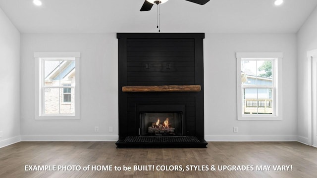 details with ceiling fan, wood-type flooring, and a fireplace