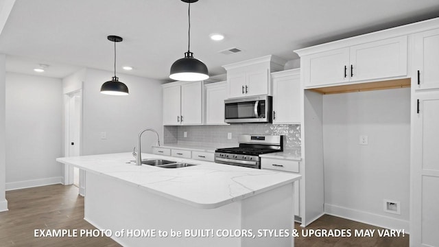 kitchen featuring appliances with stainless steel finishes, a center island with sink, and white cabinets