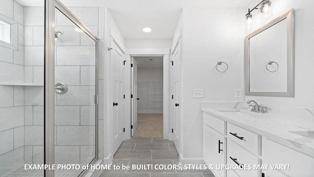 bathroom with a shower with door, vanity, and tile patterned flooring