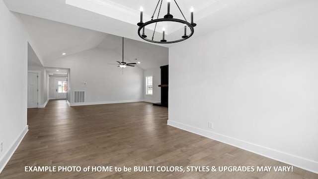 unfurnished living room featuring ceiling fan with notable chandelier, dark wood-type flooring, and a healthy amount of sunlight