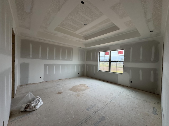 empty room featuring a raised ceiling