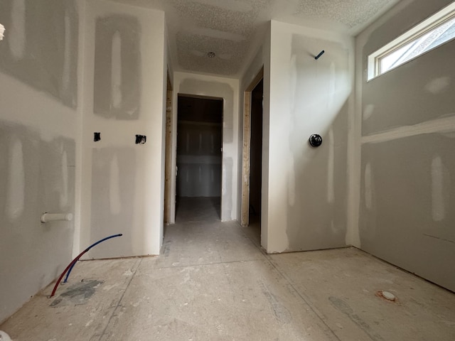 corridor with a textured ceiling