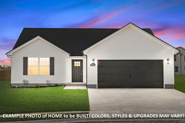 view of front of home with a garage and a lawn