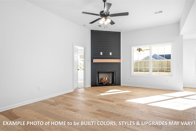 unfurnished living room featuring ceiling fan, a large fireplace, and light wood-type flooring