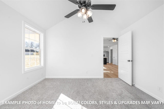 spare room with lofted ceiling, light carpet, and baseboards