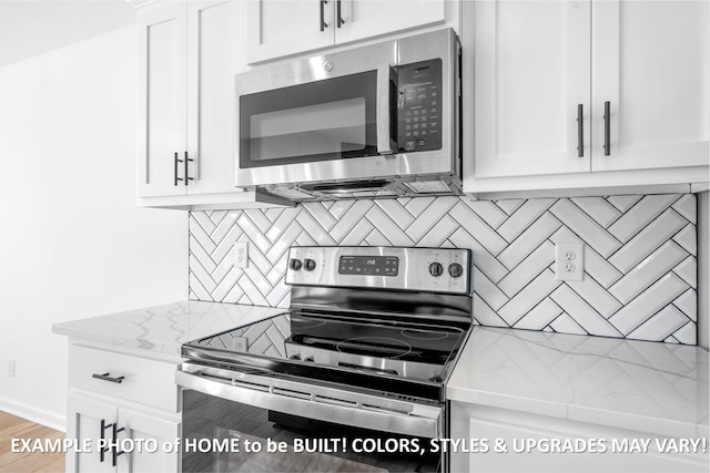 kitchen with white cabinetry, appliances with stainless steel finishes, decorative backsplash, and light stone counters