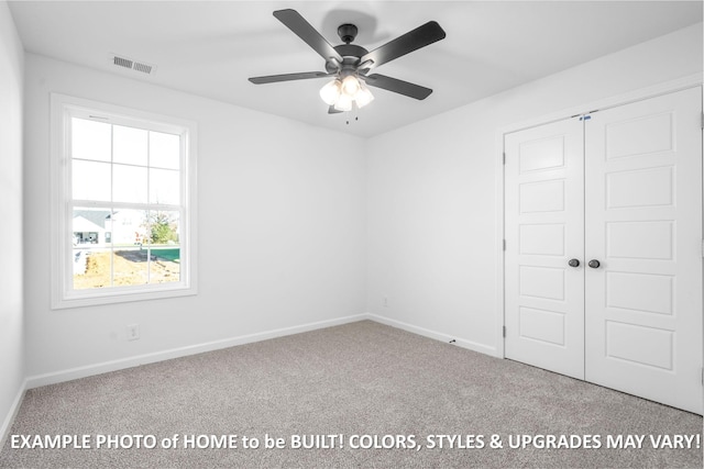 unfurnished bedroom featuring baseboards, carpet, visible vents, and a closet