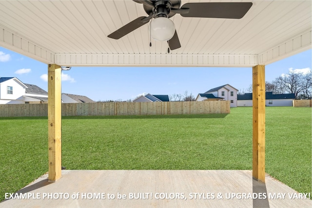 view of yard featuring ceiling fan and fence