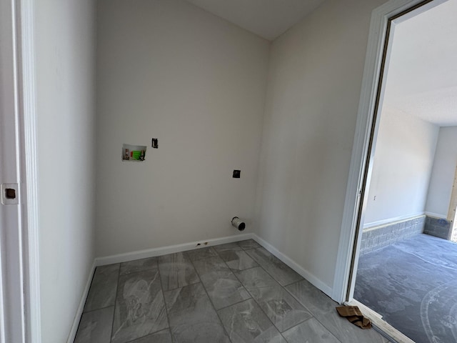 laundry area with laundry area, washer hookup, electric dryer hookup, and baseboards