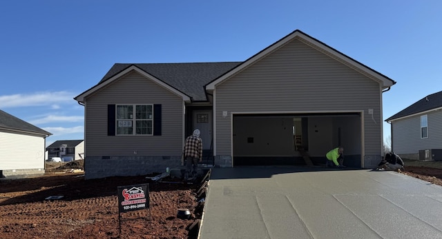 view of front of property with roof with shingles, concrete driveway, crawl space, a garage, and cooling unit