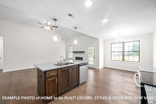 kitchen featuring stainless steel appliances, visible vents, hanging light fixtures, a sink, and light stone countertops