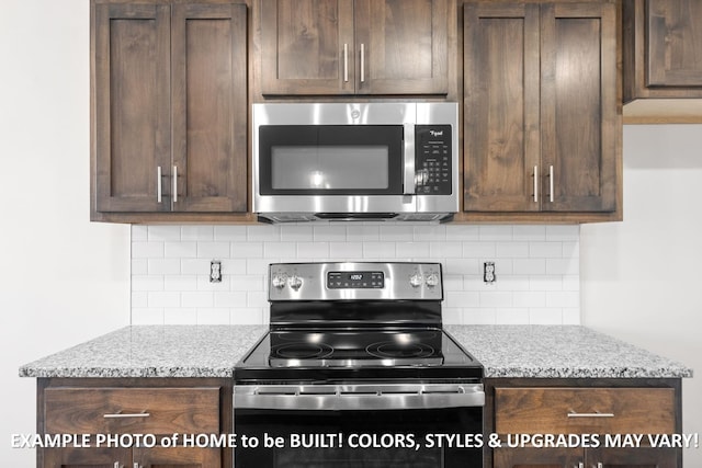 kitchen with light stone countertops, appliances with stainless steel finishes, and dark brown cabinets