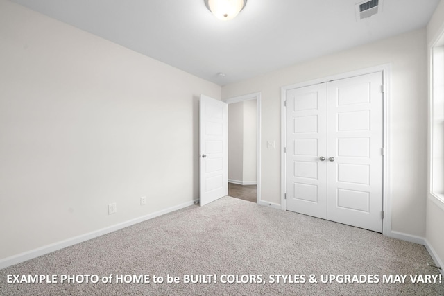 unfurnished bedroom with carpet floors, a closet, visible vents, and baseboards