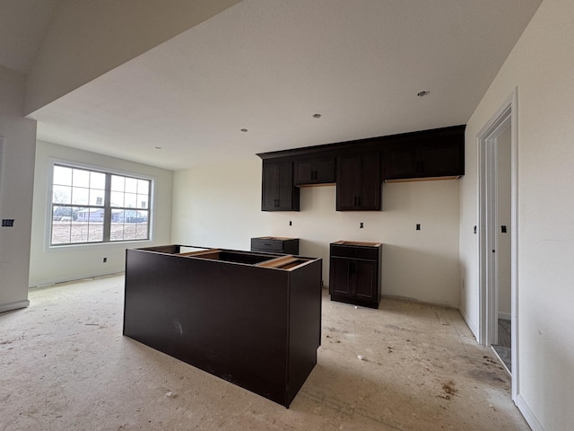 kitchen with a center island and dark brown cabinets