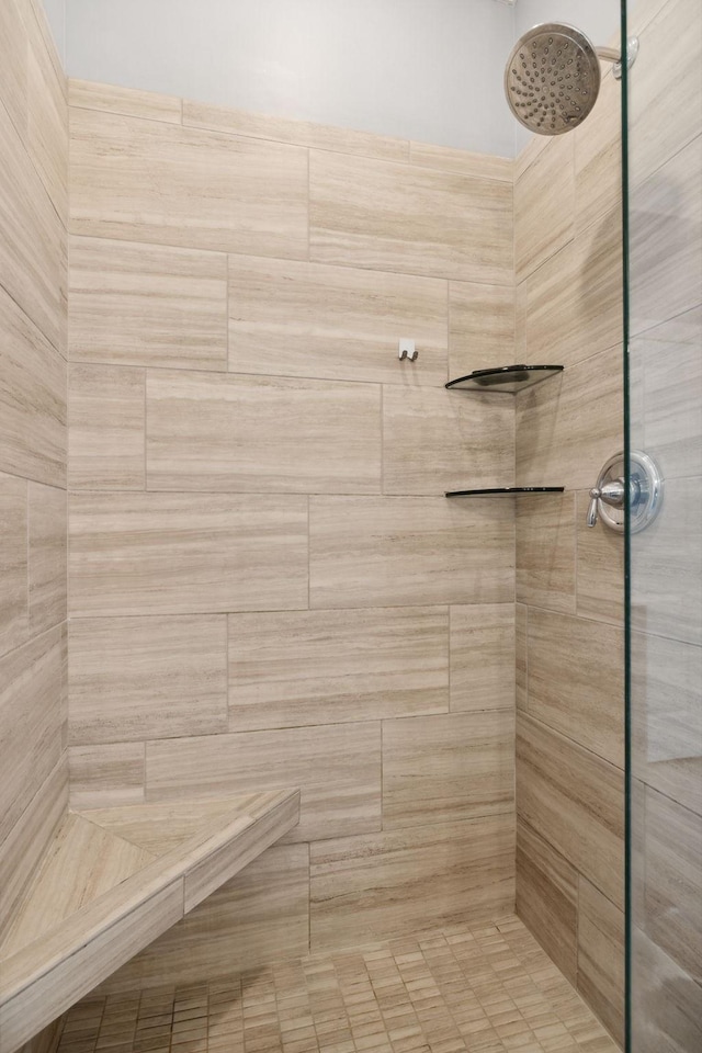 bathroom with tiled shower