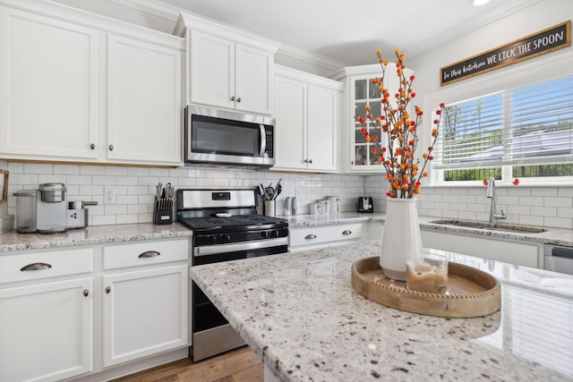 kitchen featuring white cabinetry, sink, and appliances with stainless steel finishes