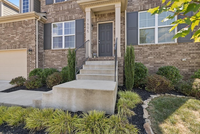 view of exterior entry with a garage